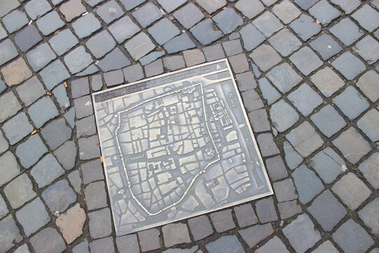 Roman city map plaque on cobblestone street in Cologne, Germany