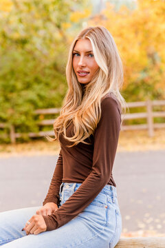 Beautiful young woman looking back in autumn park