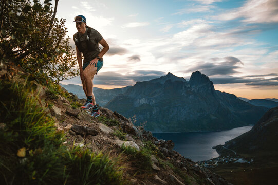 Trail runner climbing a steep ridge in Norway