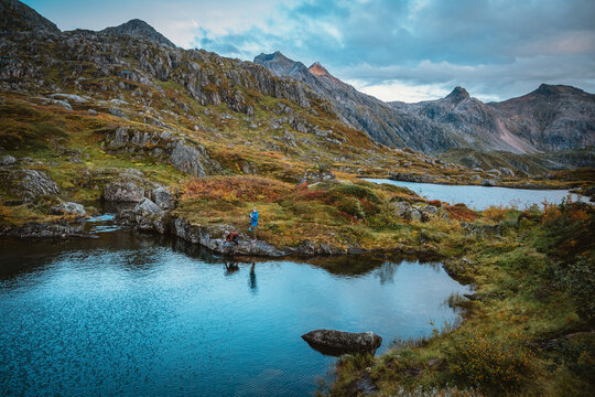 Hiker and dog enjoy a majestic mountain lake view