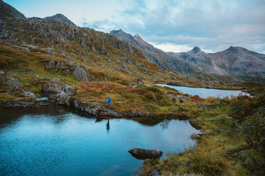 Two hikers take a break by a pristine mountain lake