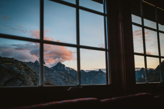 Mountain range seen through a window at sunset