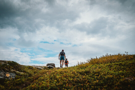 Two trail runners hiking up a trail