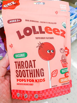 Lolleez organic throat soothing pops for kids package held by hand in a store. - Auburn WA USA - August,21 2026