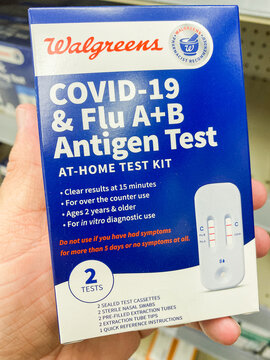Hand holding Walgreens COVID 19 and Flu AB antigen test kit box in store. - Auburn WA USA - August,21 2026