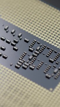 CPU chip base with gold contact pads and small dark capacitors. Pads transfer power and data through motherboard socket. Concept of hightech hardware engineering