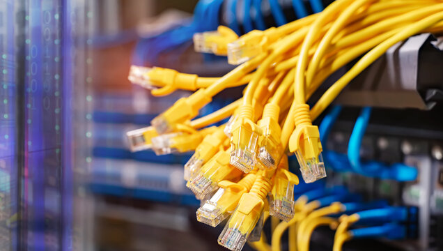 many RJ45 head of UTP LAN network cable and Lots of Ethernet cables background for connect computer and network devices to switch or hub modem router in cabinet.