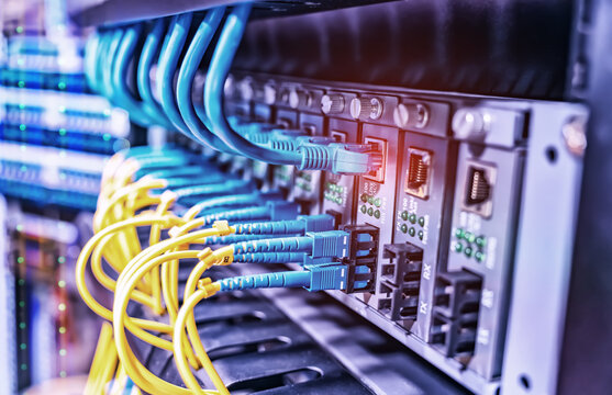 Fiber Optic cables connected to an optic ports and Network cables connected to ethernet ports and UTP Network