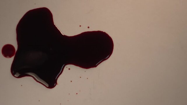 Dark red blood dripping on floor in overhead top view, off-center left positioning, mysterious mood for crime scene investigation 