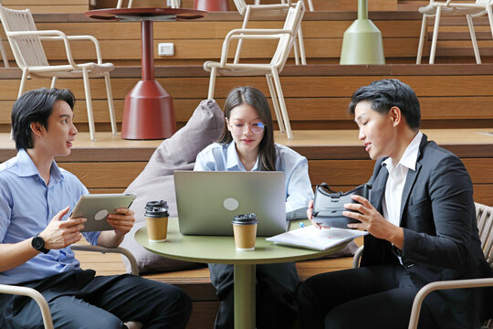 Diverse Business Team Discussing Virtual Reality Technology in Modern Workspace