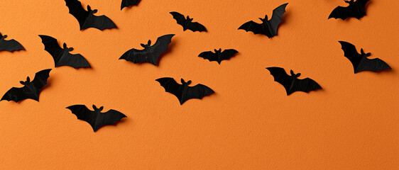 Fototapeta premium Paper Bats Flying on Orange Background Halloween Banner