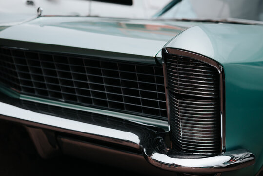 The front grille of a classic car features a detailed and distinct design. The chrome accents and mesh pattern highlight the craftsmanship common in vintage automobiles