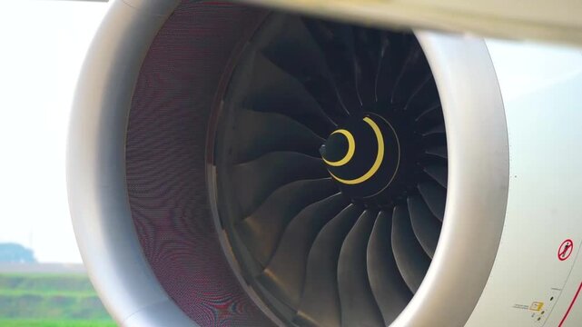 Front view close up of modern airliner jet engine turbofan spinning blades preflight safety check commercial aviation aerospace engineering stock footage