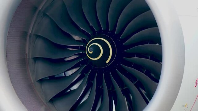 Front Angle View of Commercial Aircraft Jet Engine Intake Nacelle Frame and Rotating Fan Blades Showing Spiral Spinner Nose Cone for Civil Aviation Transport Engineering Background Video