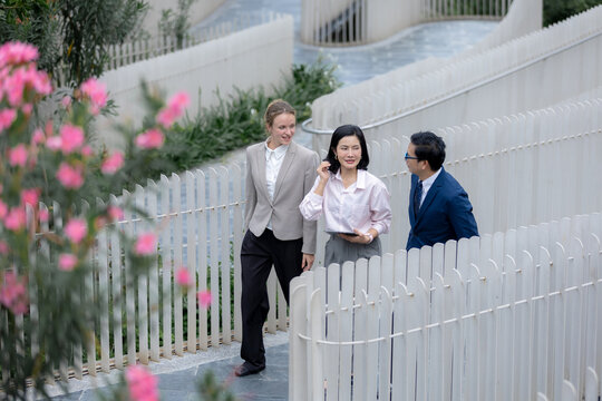 Business teamwork concept, Business person colleagues walking and discussing work outdoors in urban setting. teamwork, business, colleagues, communication, professional.