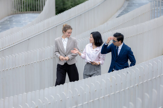 Business teamwork concept, Business person colleagues walking and discussing work outdoors in urban setting. teamwork, business, colleagues, communication, professional.