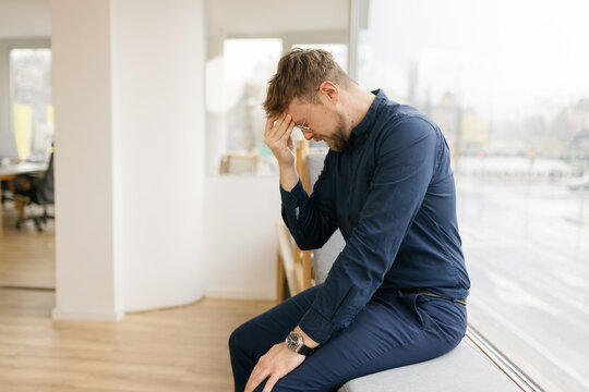 A stressed businessman experiences burnout in the office