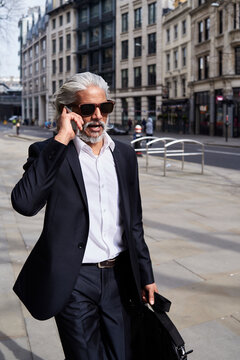Portrait of smart senior businessman talking on the phone