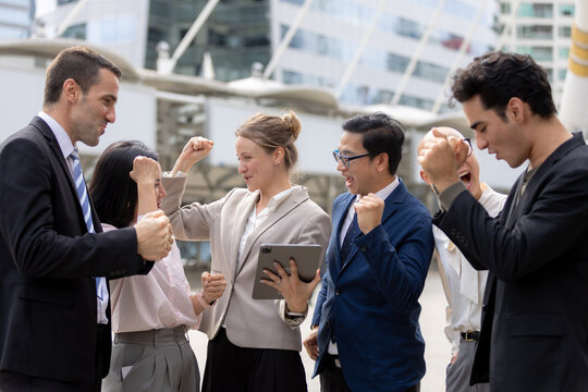 Business success concept, Colleagues cheering and celebrating teamwork achievement outdoors in corporate area. success, teamwork, business, celebration, achievement.