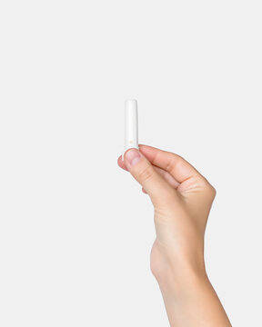 Hand Holding Small White Plastic Nasal Inhaler On White Background