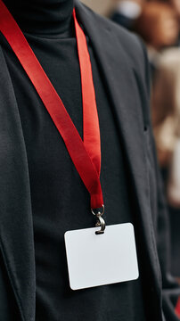 Black jacket with blank white identification badge on red lanyard