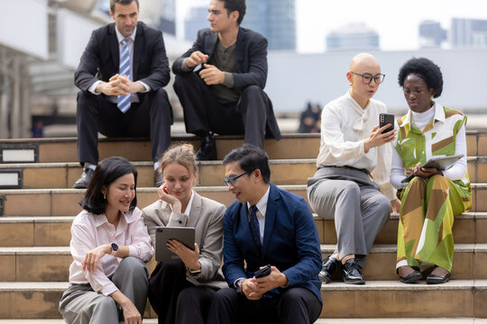 Business teamwork concept, Businessperson brainstorm colleagues discussing ideas and using tablets together while sitting outdoors in corporate setting. teamwork, business, collaboration, tablet.