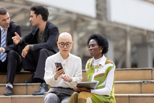 Digital teamwork concept, business colleagues using smartphone and tablet while discussing work together outdoors. teamwork, business, technology, smartphone, tablet.