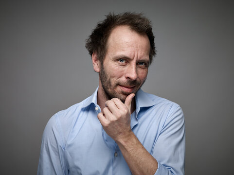 Portrait of man with han on his face