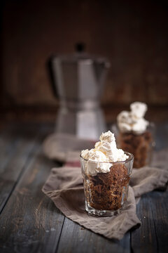 Italian coffee granita with whipped cream on a rustic wooden table