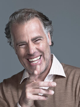 Man laughing, pointing, portrait