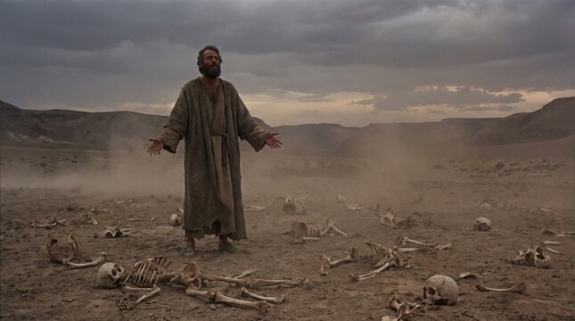 Prophet Ezekiel prophesies with outstretched hands over human skeletons in the Valley of Dry Bones Book of Ezekiel biblical scene.