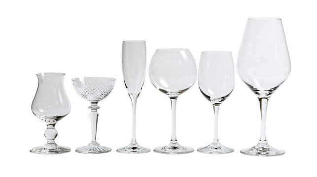 Collection of various empty crystal wine and cocktail glasses with stems