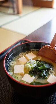 Japanese Miso Soup with Tofu and Seaweed in Black Bowl.
