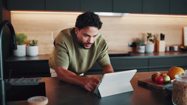 Happy man, tablet and typing in kitchen for remote work, notes or article with editing in home. Freelancer, tech and writing for email feedback, proofreading and productivity for creative report