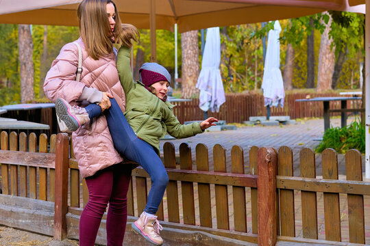 Tired mother is dealing with her naughty mischievous child daughter