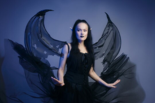 Gothic Mature Woman as Dark Elf with Wings in Blue Mist