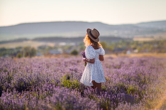 Woman lavender field exploring purple flowers sunset golden hour