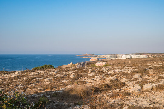 Arid and rocky landscape overlooking the sea, road and Wied Musa Battery, Marfa MALTA