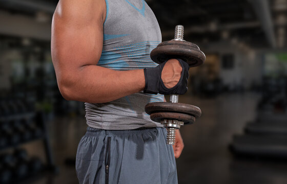 powerful latino muscular man lifting weights