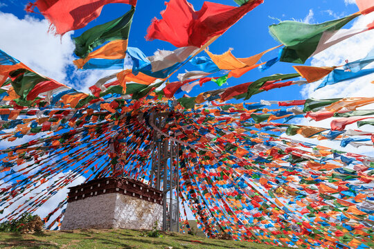 The Changqing Chunker Temple  in Litang, China. Many colourful prayer flags on the mountain top beside the temple.Spirituality and meditation.