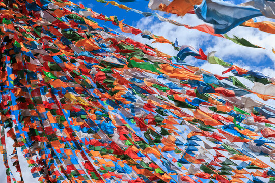 The Changqing Chunker Temple  in Litang, China. Many colourful prayer flags on the mountain top beside the temple.Spirituality and meditation.