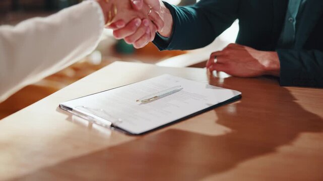 Man, handshake and signature in house with document, lease contract and form for administration. People, legal paperwork or shaking hands with rental agreement for insurance policy, mortgage or loan