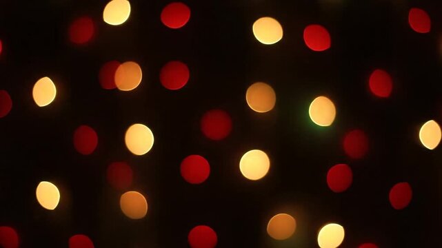 Red and gold bokeh lights on black background