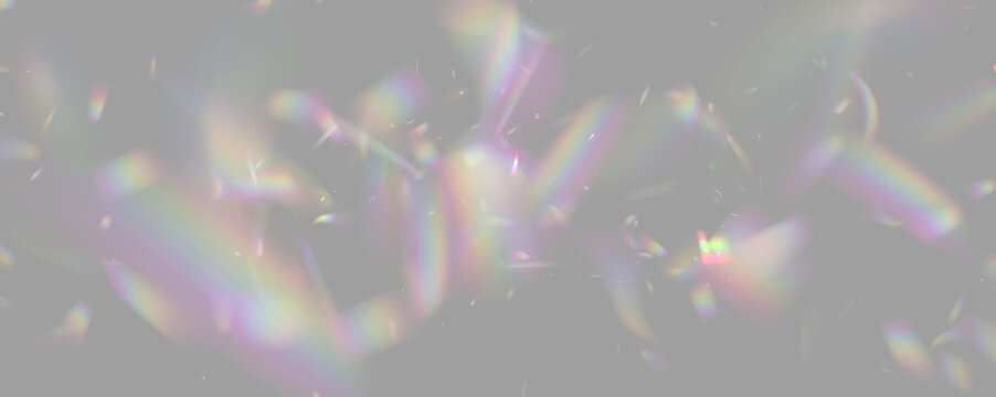 Colorful light refraction creates scattered rainbow fragments. Iridescent shapes vary in size and intensity against a black background. This image suits digital art and abstract concept.