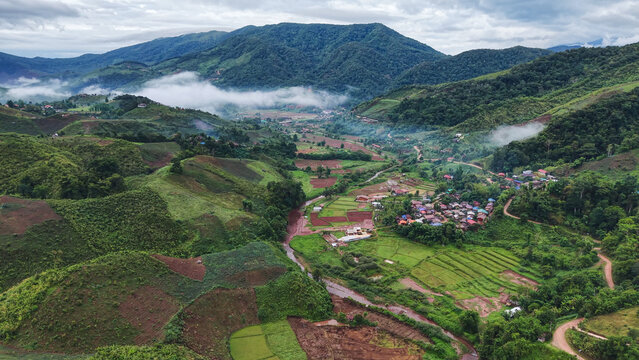Aerial view from drone of the rural village in the mountains on foggy morning, Nan province, Thailand