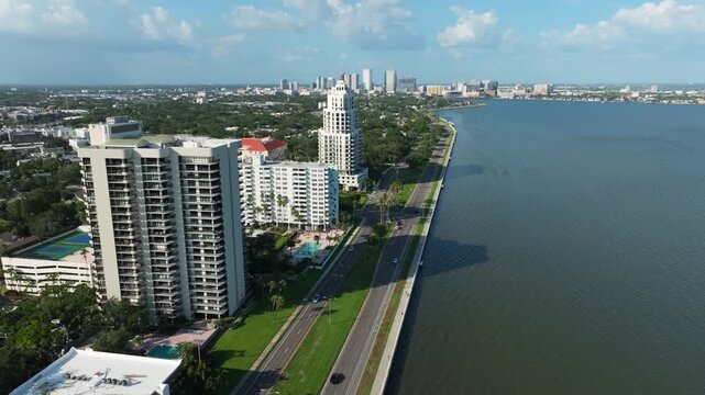 Aerial view of Bayshore Boulevard's iconic seawall promenade in Tampa, Florida, with waterfront high-rises overlooking the wide expanse of Hillsborough Bay.