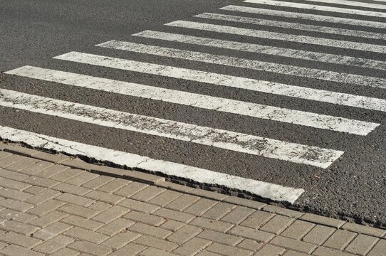 White Zebra Crossing On Asphalt Road