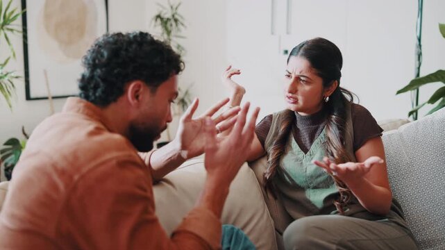 Upset, couple and conflict at house with argument, confrontation and separation of broken trust. Stress, people or jealousy on sofa for disagreement, insecurity and breakdown for infidelity suspicion