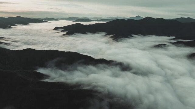 Mystical Sea of Clouds Over Mountain Range at Sunrise or Sunset