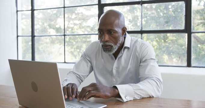 Lifestyle videos indoor of people doing activities at office, smiling businessman using laptop in mo